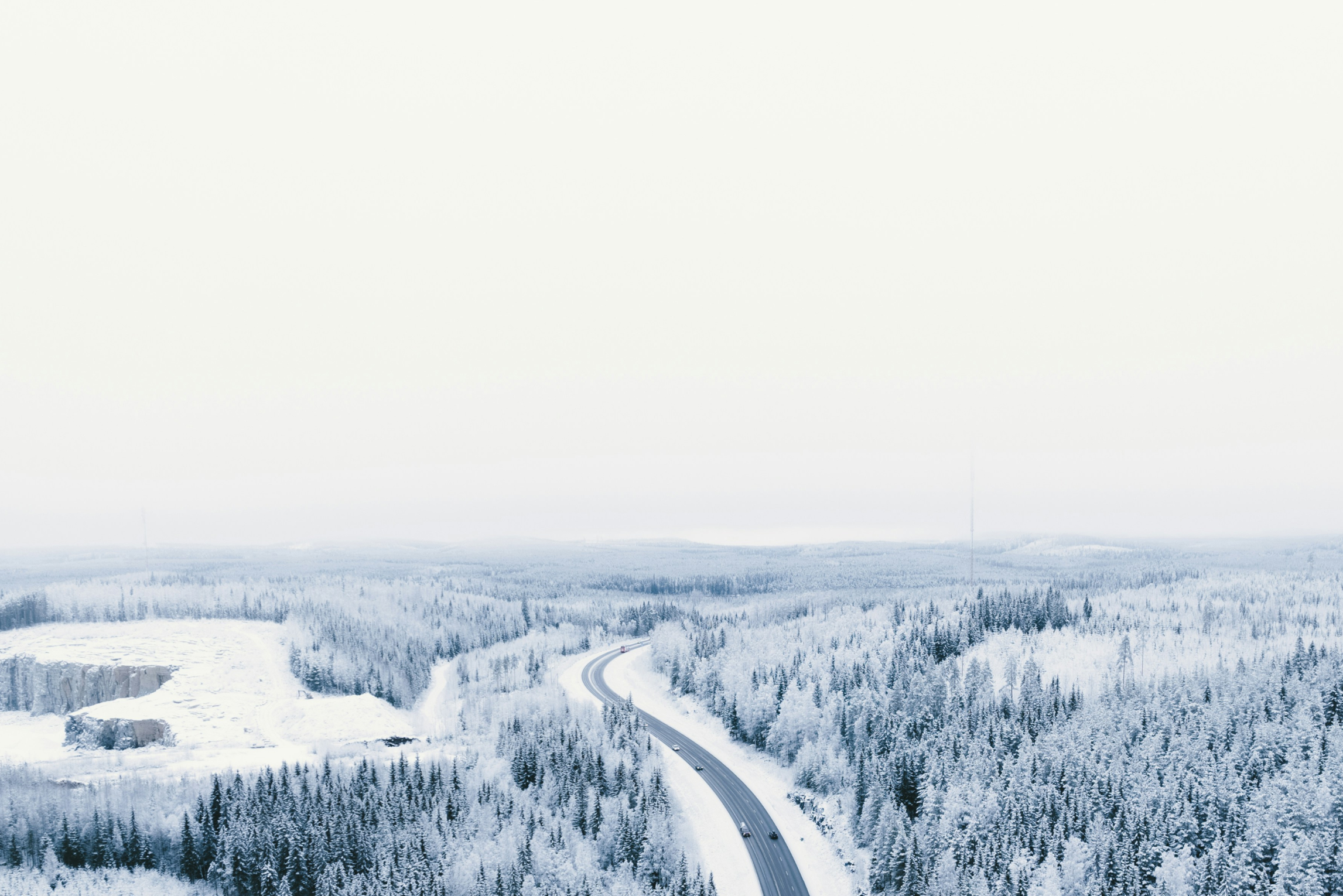 Vinter och en väg som går mellan skogar